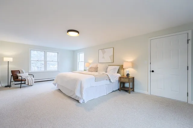 a bed room with a bed and a chair