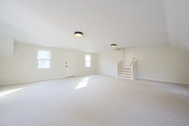 an empty room with windows and pillars in it