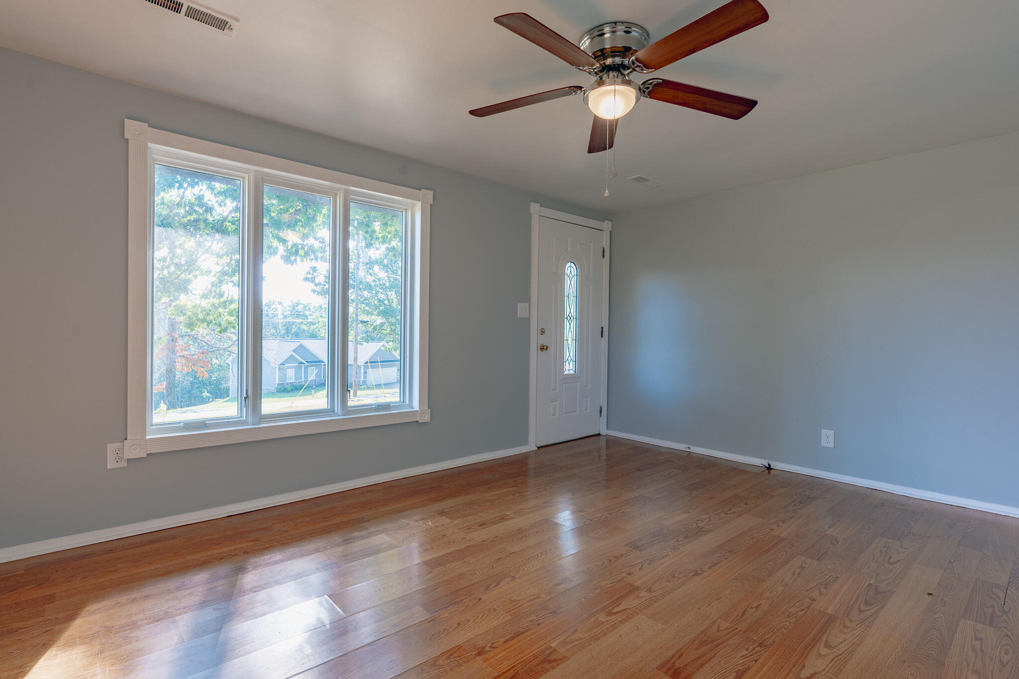 1737 Beagle Club Road Vinton, VA 24179 - Photo 34 of 45 an empty room with wooden floor fan and windows
