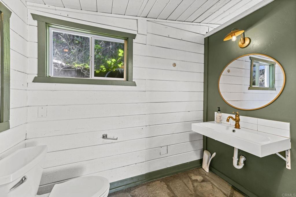 838 East Mission Road Fallbrook, CA 92028 - Photo 21 of 48 a bathroom with a sink a toilet and a mirror