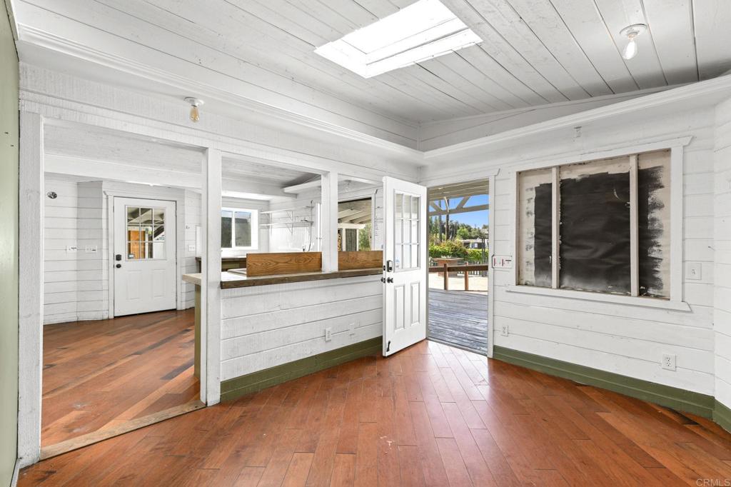 838 East Mission Road Fallbrook, CA 92028 - Photo 10 of 48 a view of a bedroom with wooden floor and windows