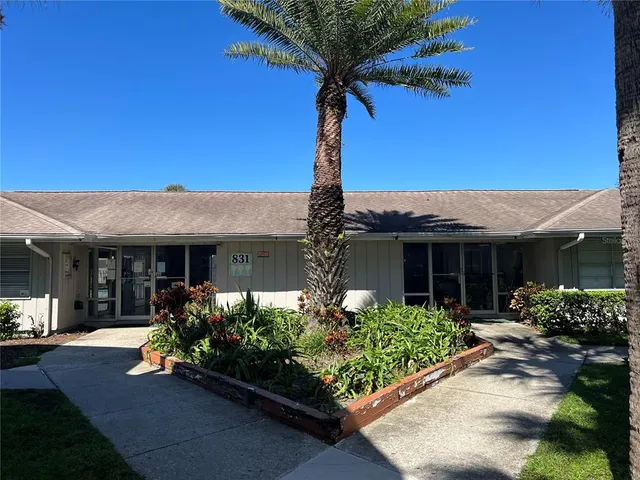 a view of a house with a backyard