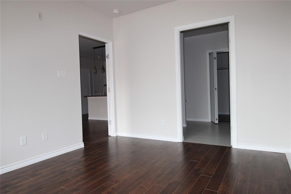 1100 West Trinity Mills Road, Unit 3035 Carrollton, TX 75006 - Photo 10 of 12 an empty room with wooden floor and closet
