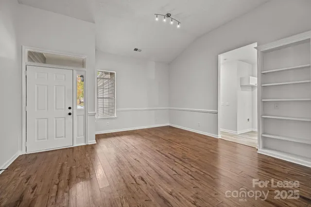 an empty room with wooden floor