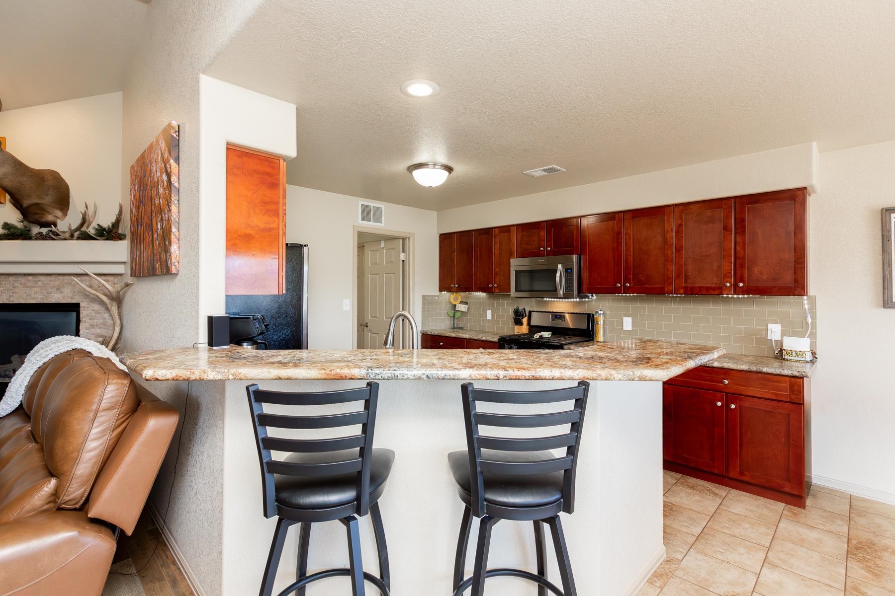 103 Red Rocks Street Fruita, CO 81521 - Photo 22 of 39 a kitchen with a table chairs sink refrigerator and cabinets