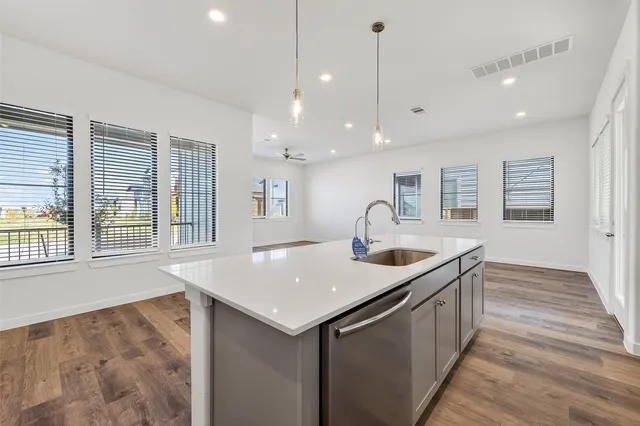 a kitchen with stainless steel appliances granite countertop a sink and window