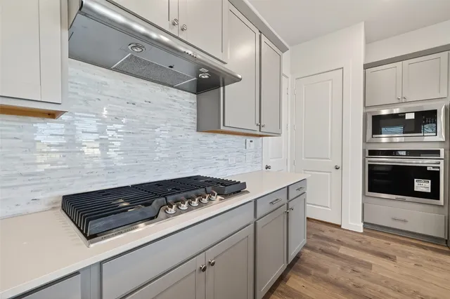 a kitchen with sink cabinets and stove top oven