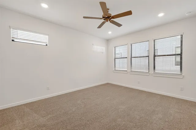 an empty room with closet and windows