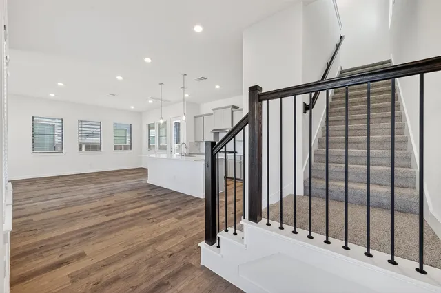 a view of entryway with wooden floor and stairs