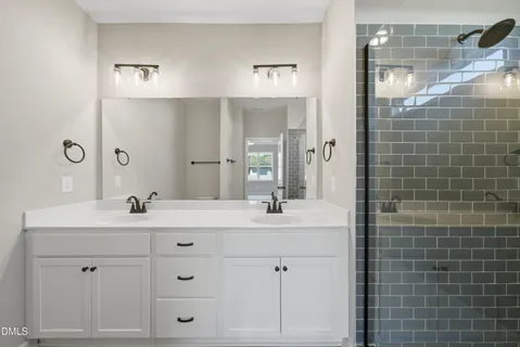 a bathroom with a double vanity sink mirror and