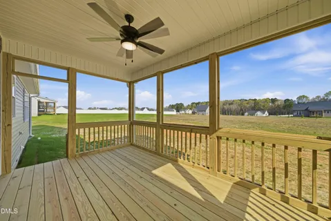 a view of a balcony with wooden floor & fence