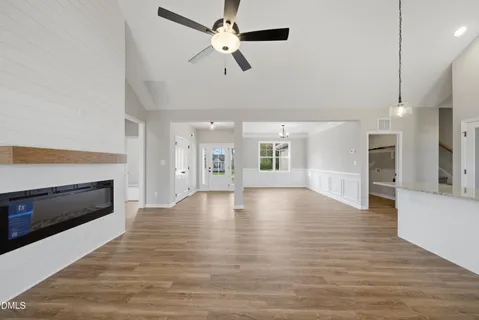 a view of an empty room with a fireplace and a window