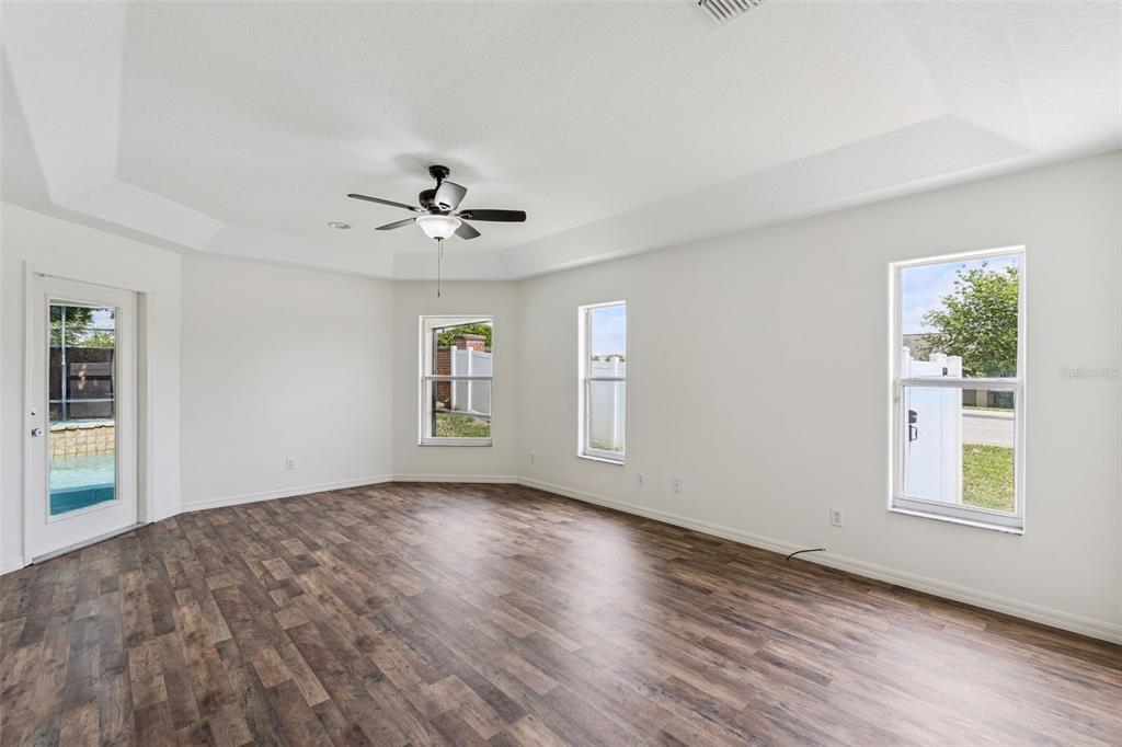 2440 Holly Ridge Court Clermont, FL 34711 - Photo 11 of 43 a view of an empty room with a window and wooden floor