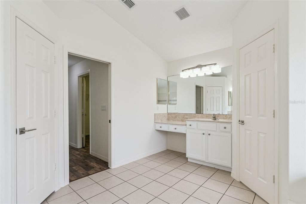 2440 Holly Ridge Court Clermont, FL 34711 - Photo 13 of 43 a bathroom with a sink a mirror and a shower