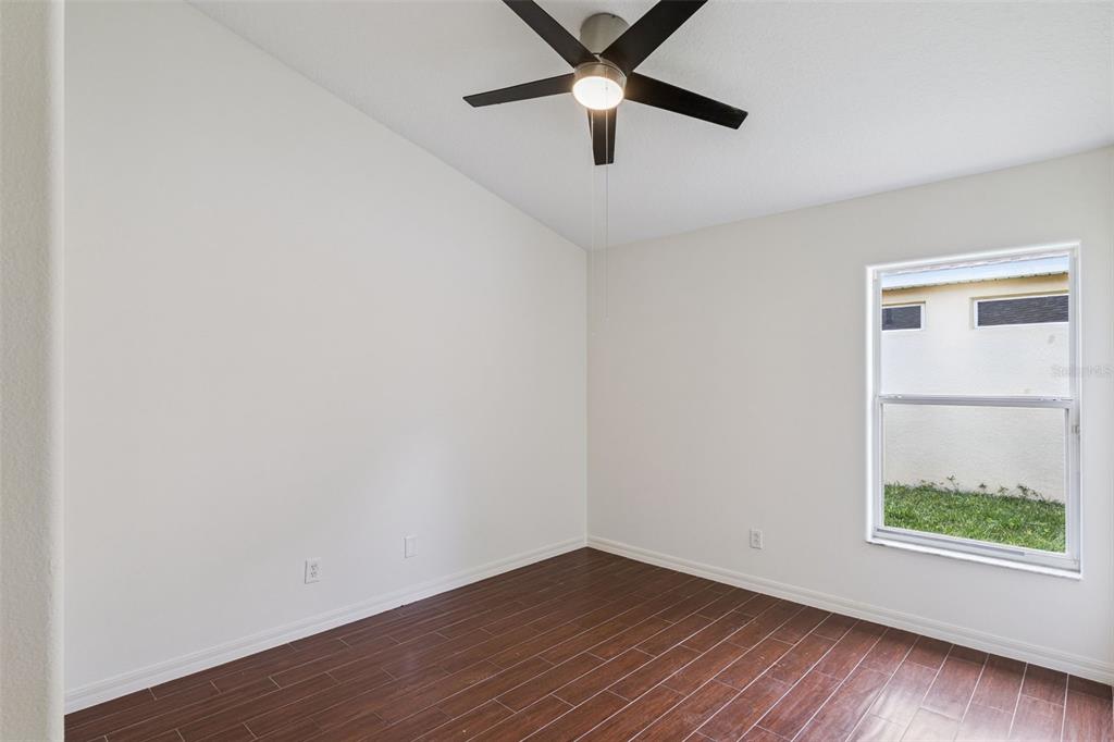 2440 Holly Ridge Court Clermont, FL 34711 - Photo 14 of 43 an empty room with a window and a ceiling fan