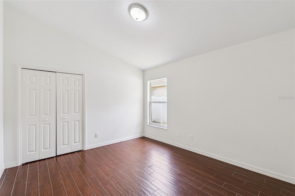 2440 Holly Ridge Court Clermont, FL 34711 - Photo 17 of 43 an empty room with wooden floor and windows