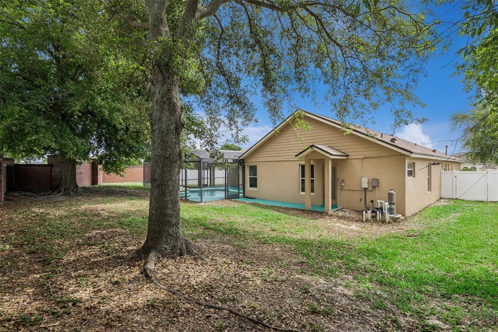 2440 Holly Ridge Court Clermont, FL 34711 - Photo 25 of 43 a view of a house with a yard and large trees