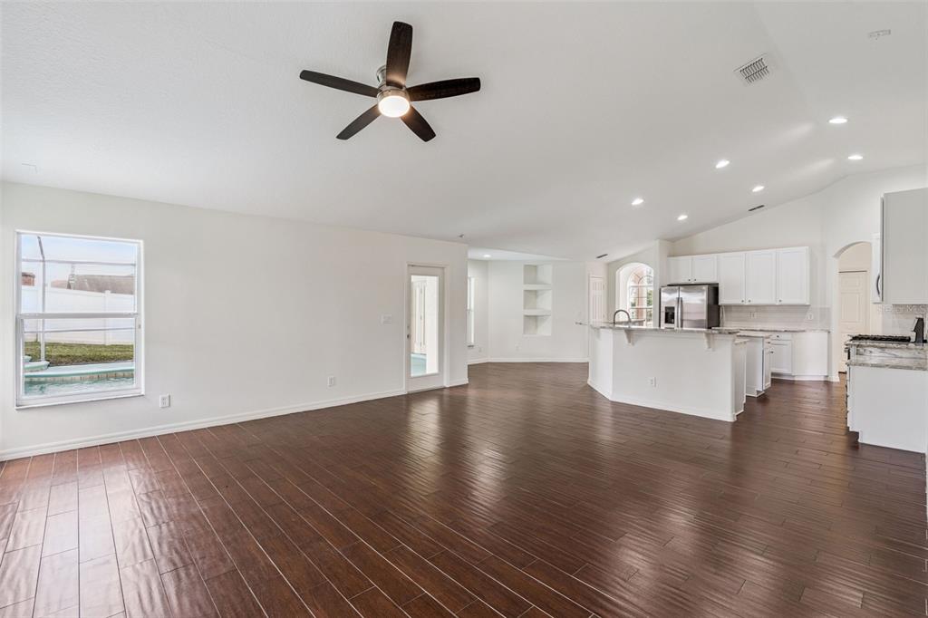 2440 Holly Ridge Court Clermont, FL 34711 - Photo 28 of 43 a view of empty room with wooden floor and window