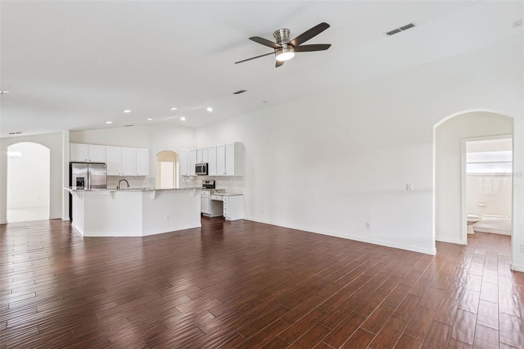 2440 Holly Ridge Court Clermont, FL 34711 - Photo 29 of 43 a view of empty room with wooden floor and a ceiling fan