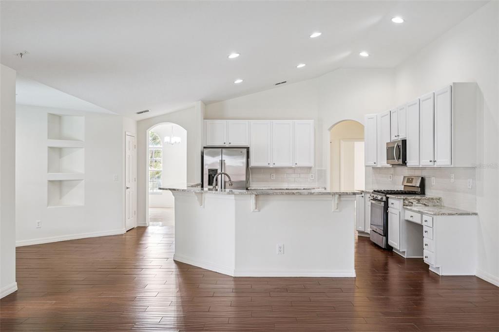 2440 Holly Ridge Court Clermont, FL 34711 - Photo 30 of 43 a view of kitchen with stainless steel appliances refrigerator stove microwave and cabinets