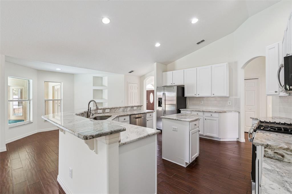2440 Holly Ridge Court Clermont, FL 34711 - Photo 31 of 43 a kitchen with sink stove and refrigerator