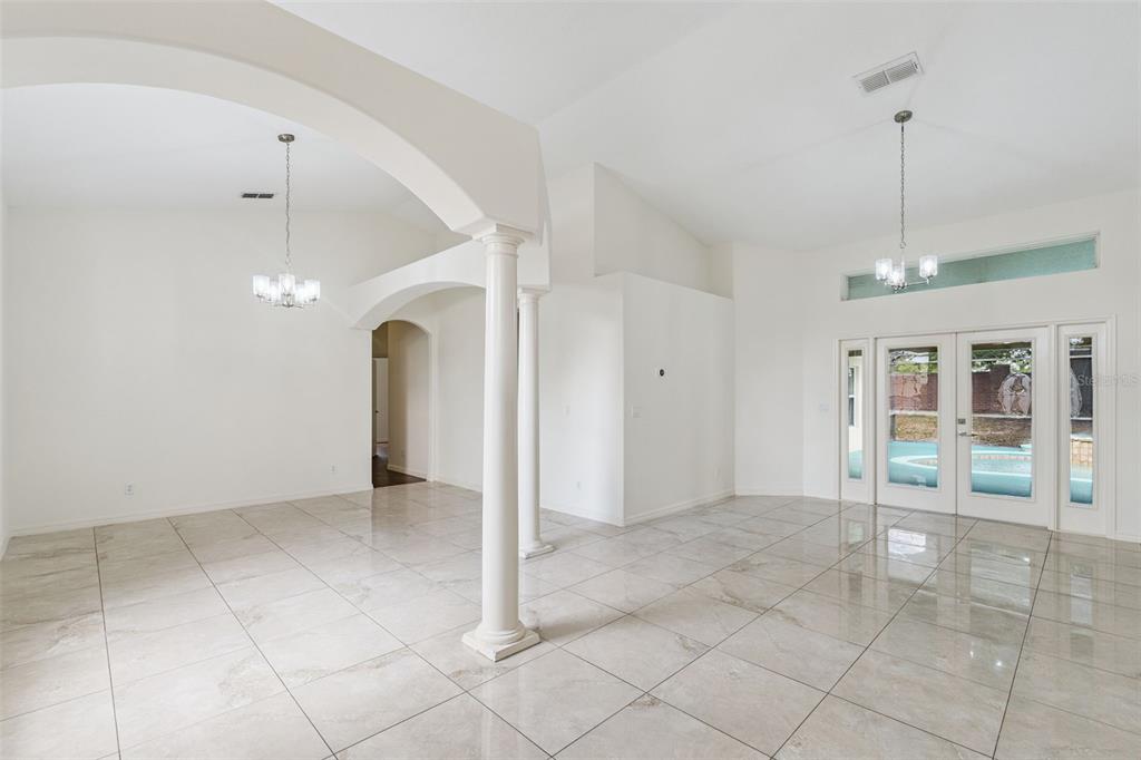 2440 Holly Ridge Court Clermont, FL 34711 - Photo 6 of 43 a view of an empty room with window and chandelier
