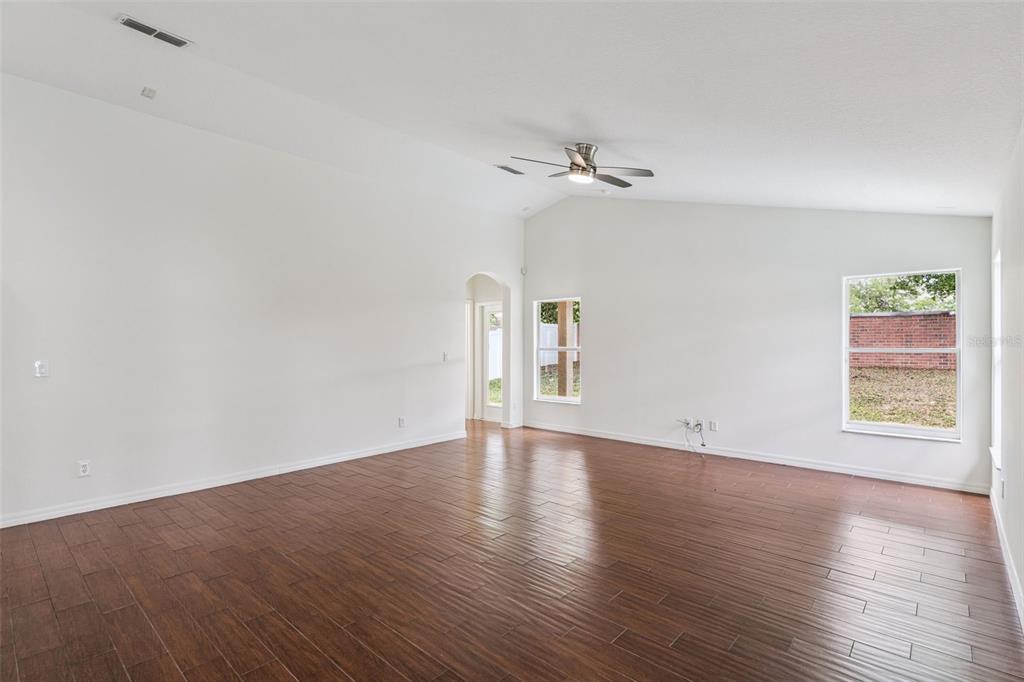 2440 Holly Ridge Court Clermont, FL 34711 - Photo 10 of 43 a view of empty room with wooden floor and fan