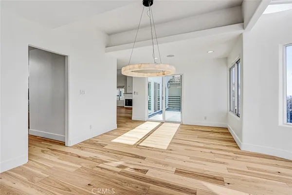 a view of a room with wooden floor