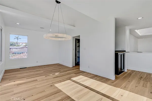 a view of a kitchen with furniture and wooden floor