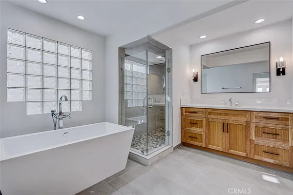 a spacious bathroom with a granite countertop sink mirror and toilet