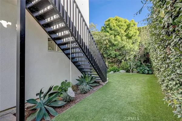 a view of a house with a yard and plants