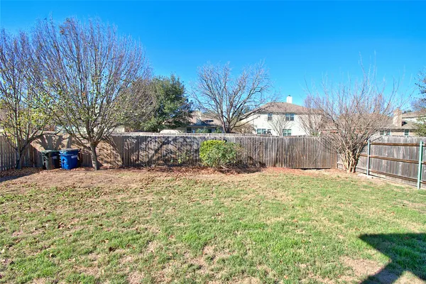a backyard of a house with lots of green space and fountain