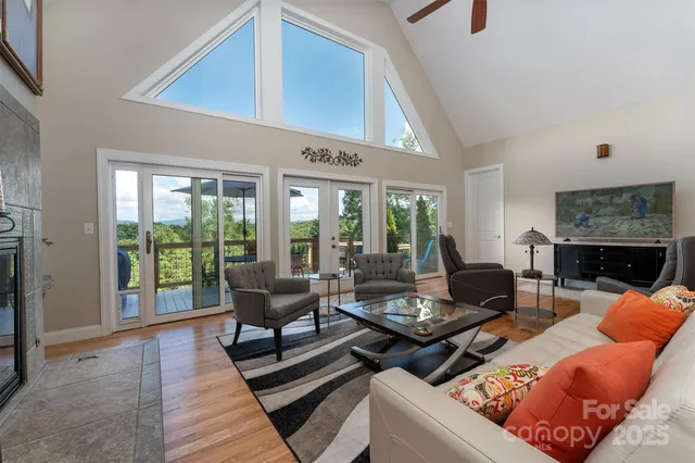a living room with furniture fireplace and a large window