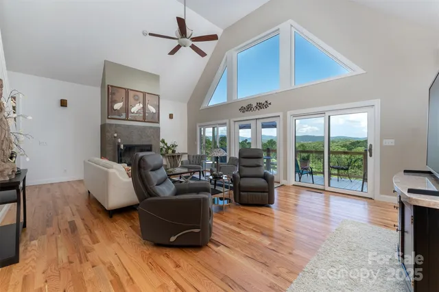 a living room with furniture wooden floor and a large window