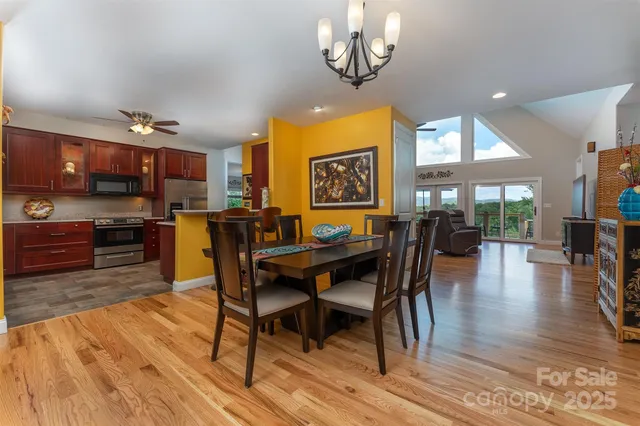 a view of a dining room with furniture wooden floor and chandelier