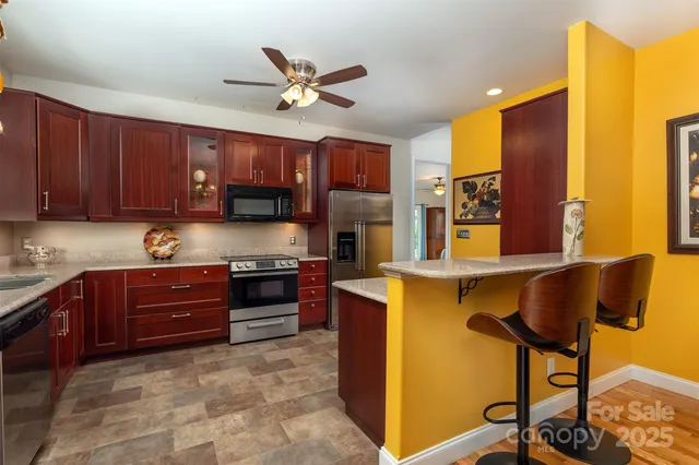 a kitchen with a stove a sink and cabinets