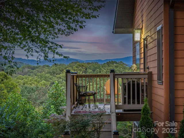 a view of a chair and table in backyard of the house