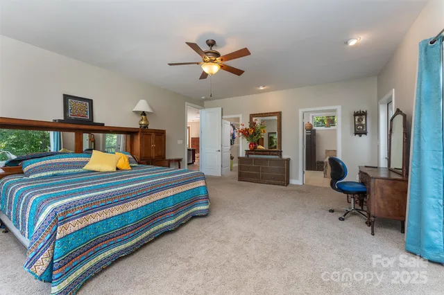 a bedroom with bed and a chandelier