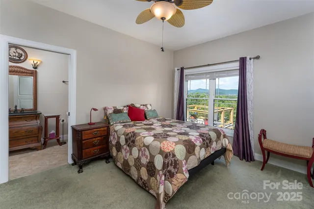 a bedroom with bed and a chandelier