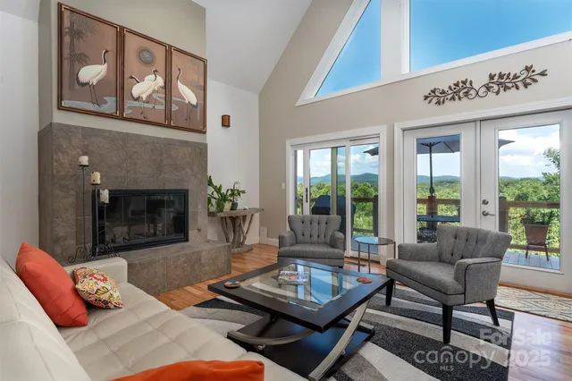 a living room with furniture a table and a fireplace