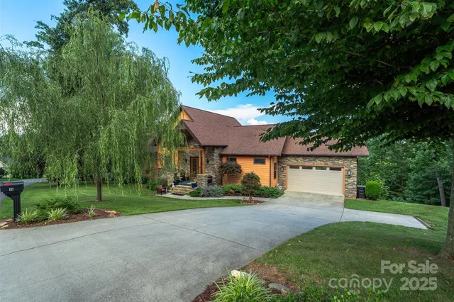 a front view of a house with a yard and green space