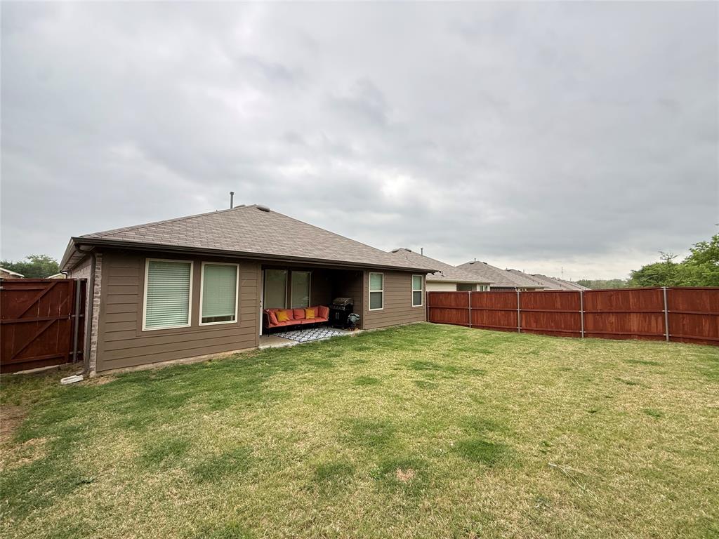 2332 Burleson Road Sherman, TX 75090 - Photo 20 of 21 a view of a house with a yard and garage