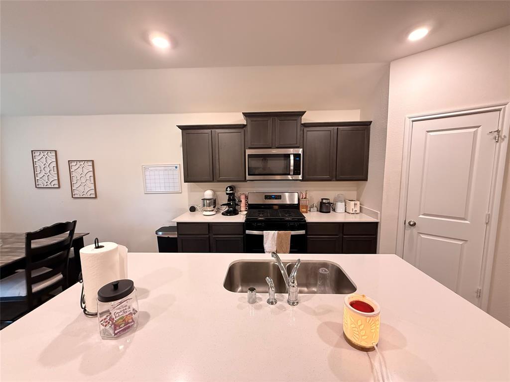 2332 Burleson Road Sherman, TX 75090 - Photo 6 of 21 a kitchen with a sink a stove and refrigerator