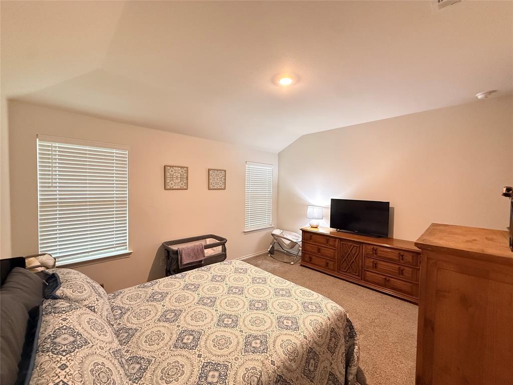 2332 Burleson Road Sherman, TX 75090 - Photo 9 of 21 a bedroom with a bed and a flat screen tv