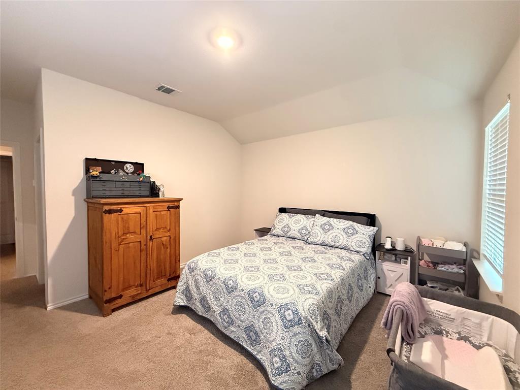 2332 Burleson Road Sherman, TX 75090 - Photo 10 of 21 a bedroom with a bed and wooden floor