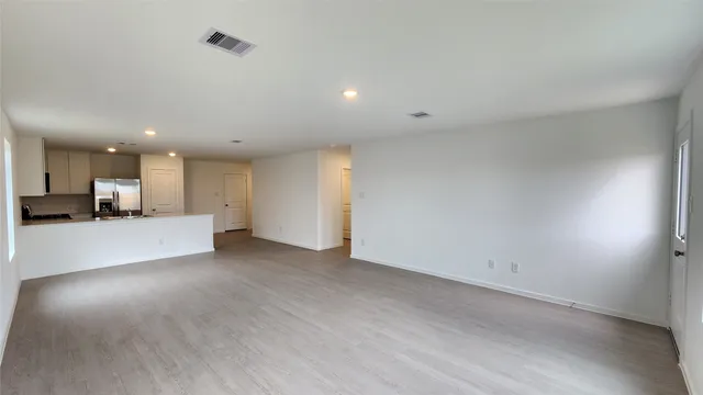 a view of kitchen and a refrigerator in a room