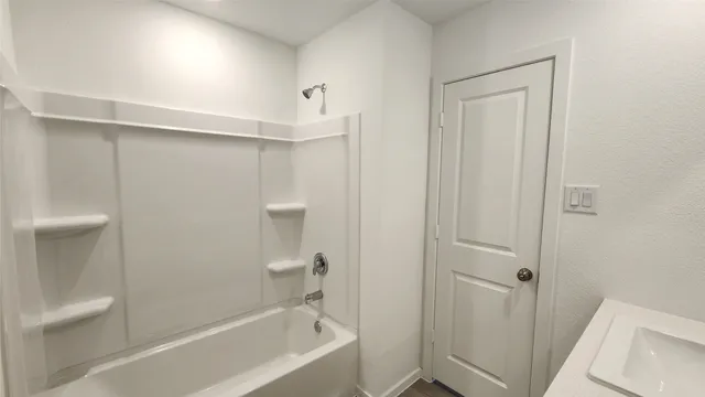 a bathroom with a bathtub and toilet