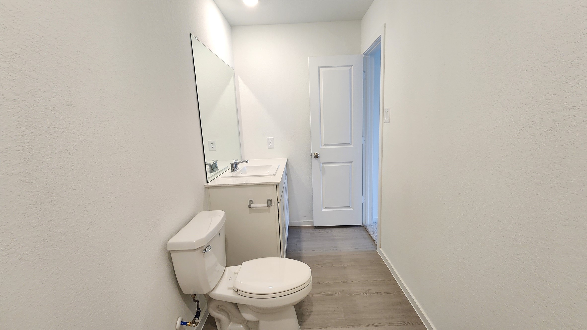 16202 Rustic Prairie Drive Hockley, TX 77447 - Photo 31 of 35 a white toilet sitting next to a white sink and vanity