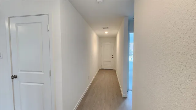 a view of a hallway with white walls