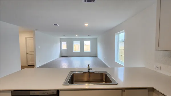 a kitchen with kitchen island a sink stove and refrigerator